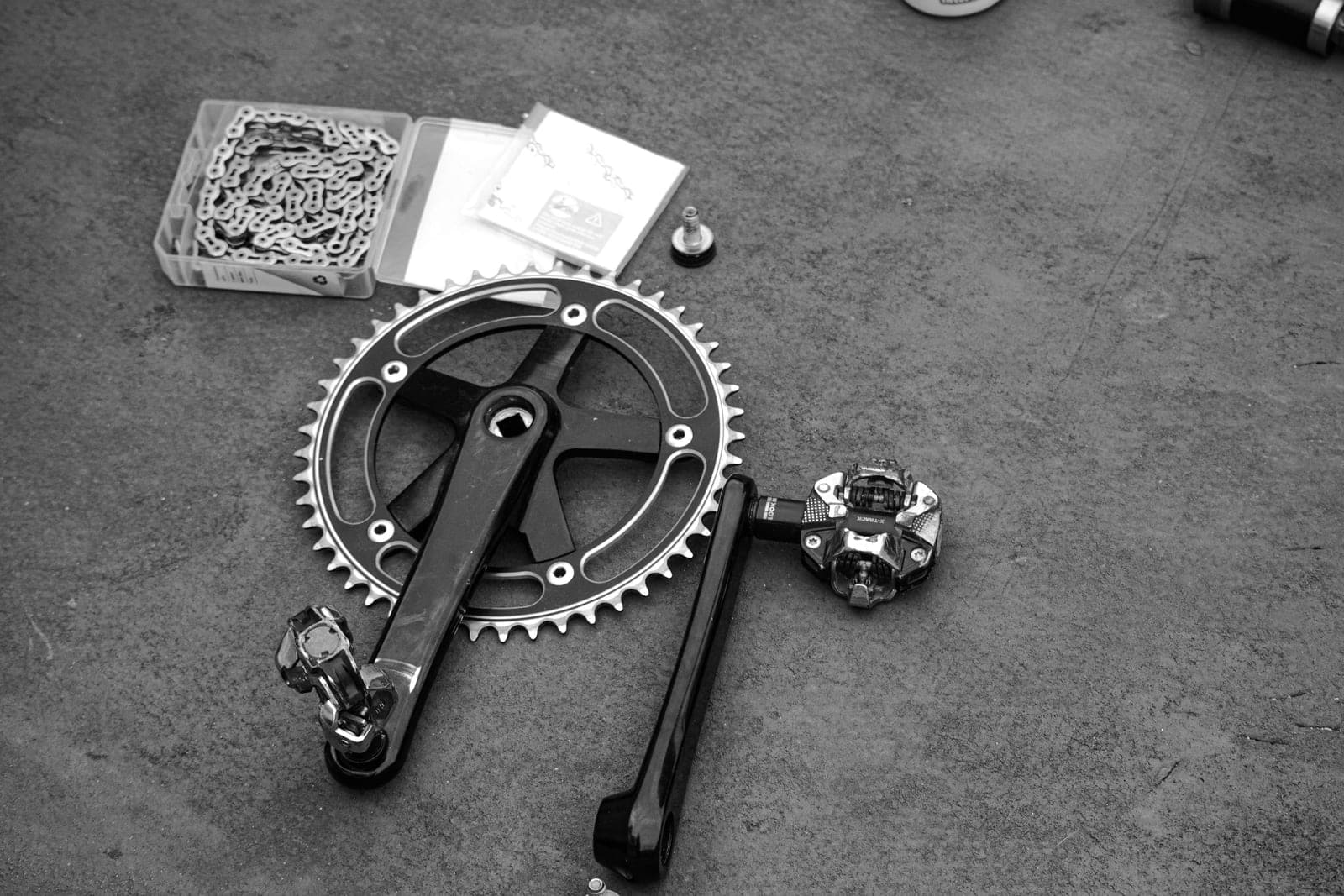 A bicycle chainset and chain photographed close up in black and white.
