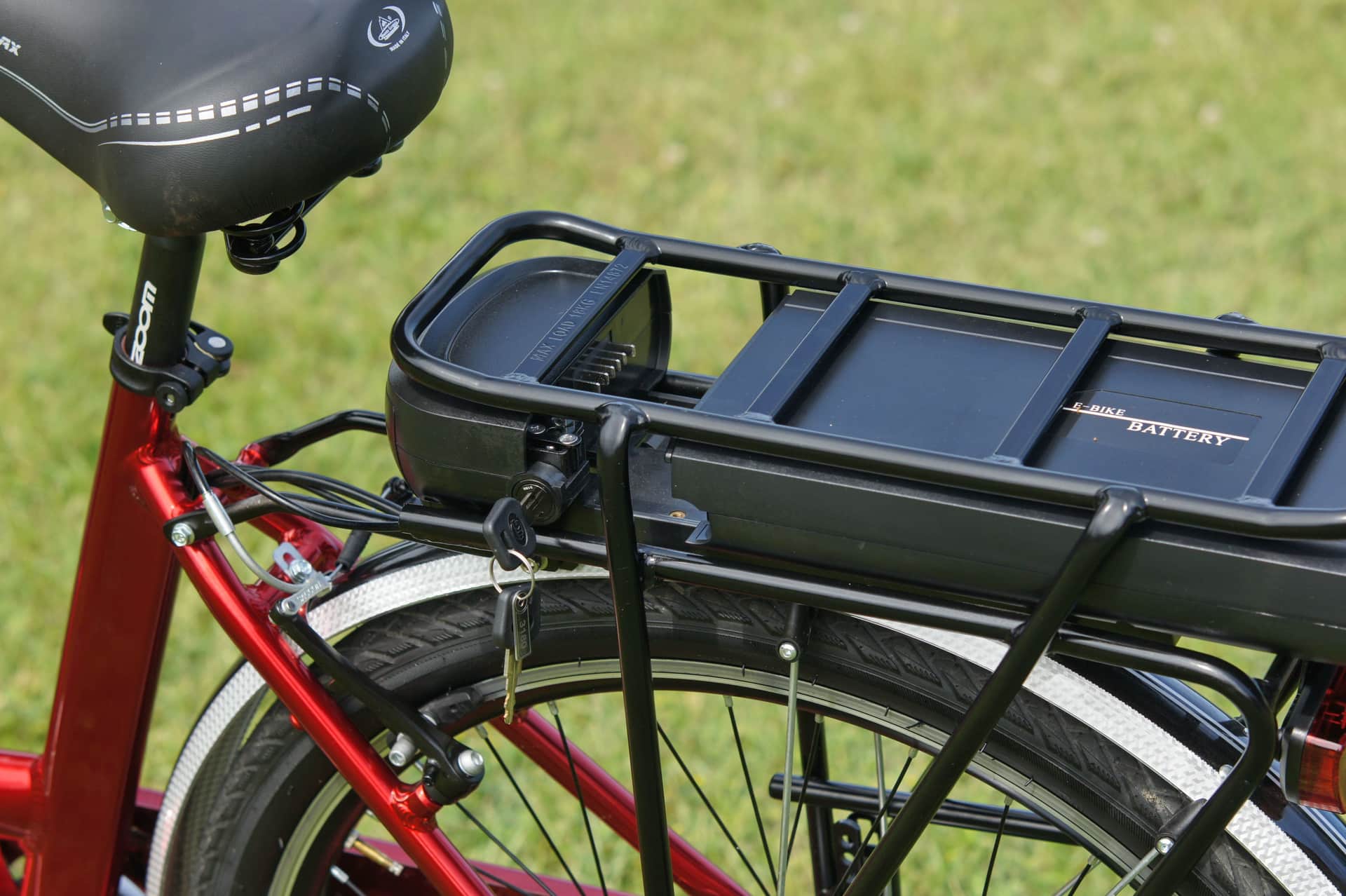 A removable electric bike battery pack resting on a workbench.