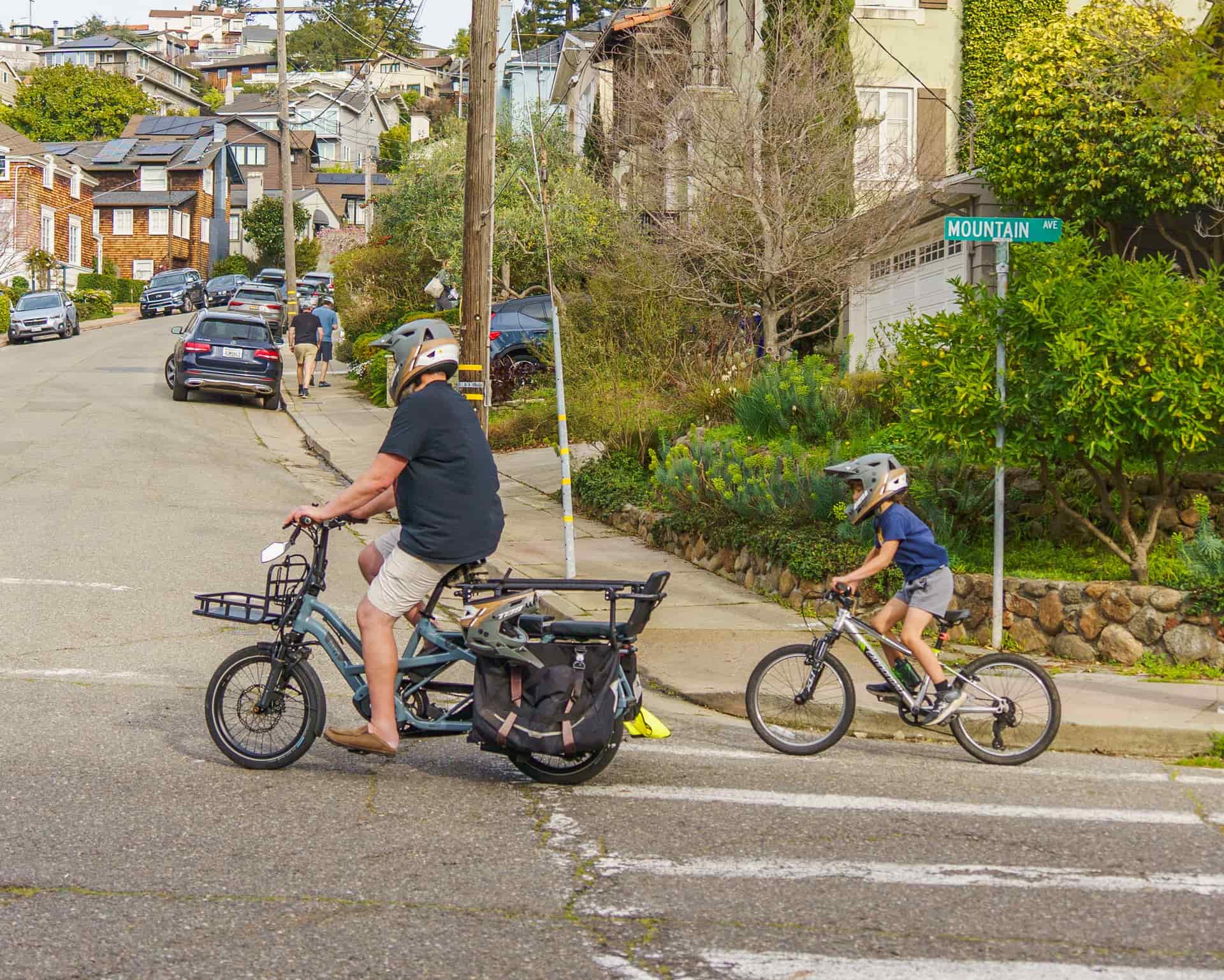 An electric bike on a shared-use path beside a park sign.