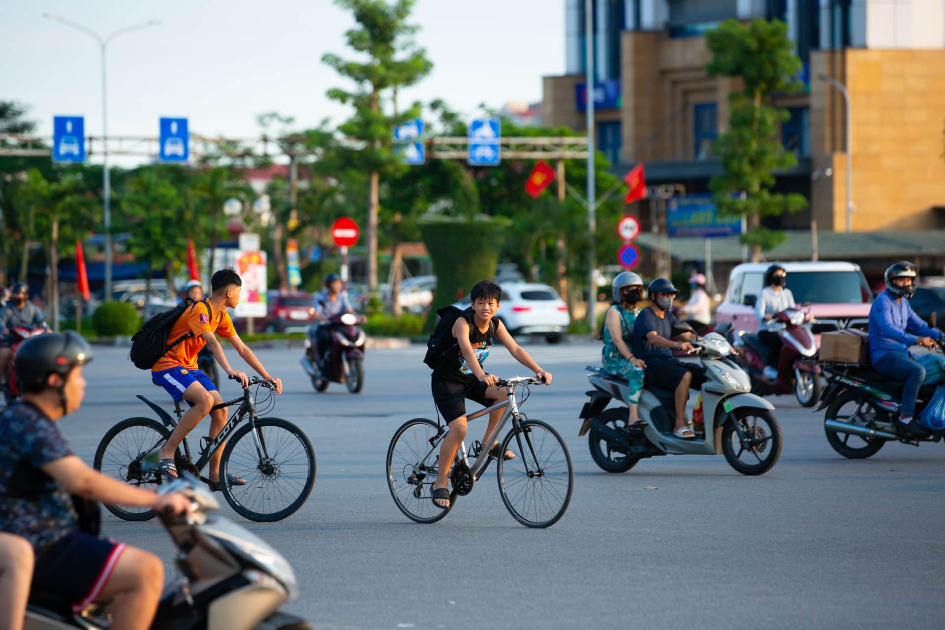 Cyclists and scooters sharing a busy city street.