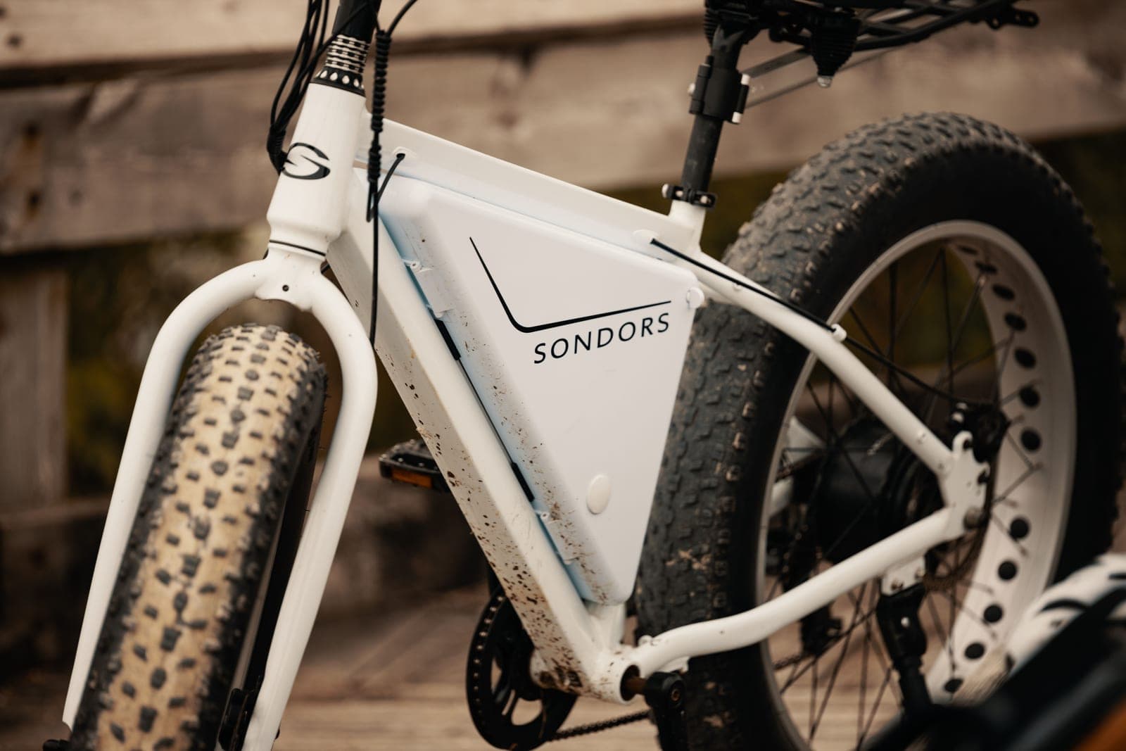 The fat tire and wheel of an electric bicycle photographed close up.