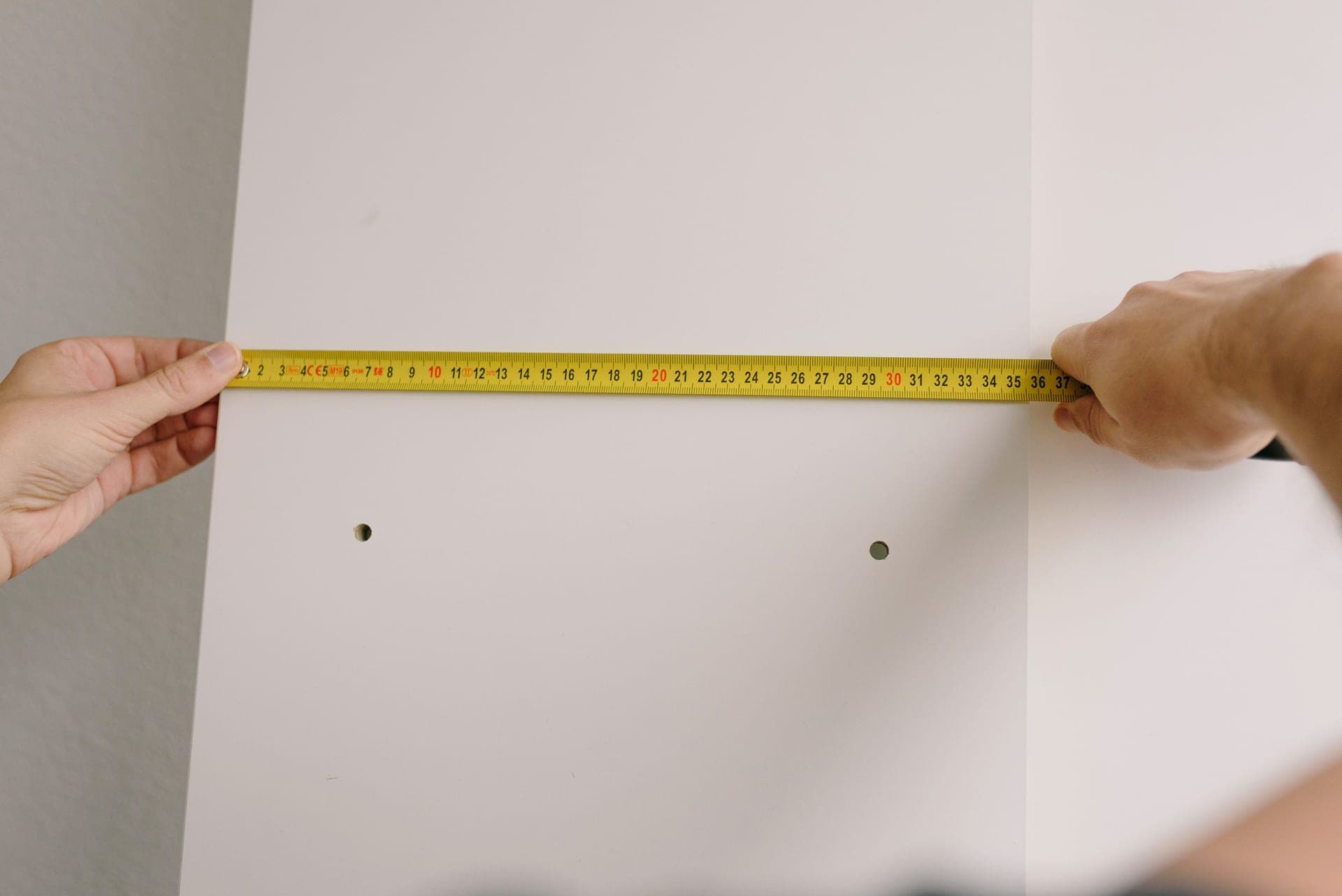 A tire sidewall showing its printed size marking next to a set of calipers on a workbench.