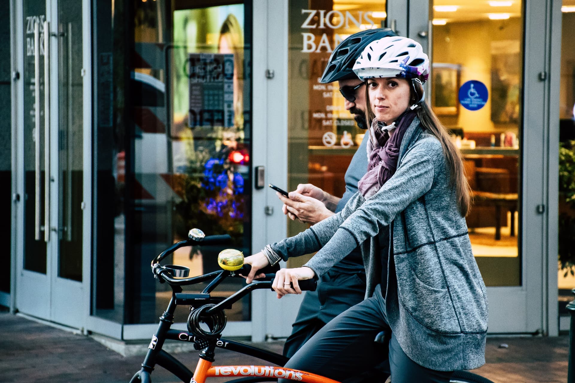A road cyclist's vented helmet sitting level and forward on the head in bright daylight.