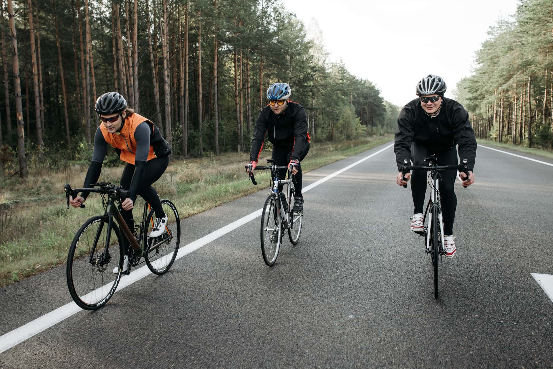 Cycling bib shorts and a jersey hanging to air-dry on a line in soft daylight.