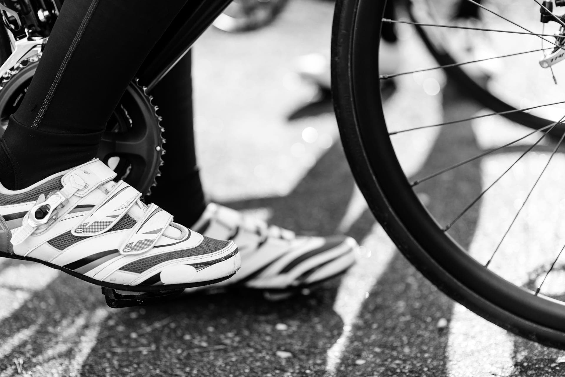 A road cycling shoe and a gravel cycling shoe side by side showing their sole patterns.