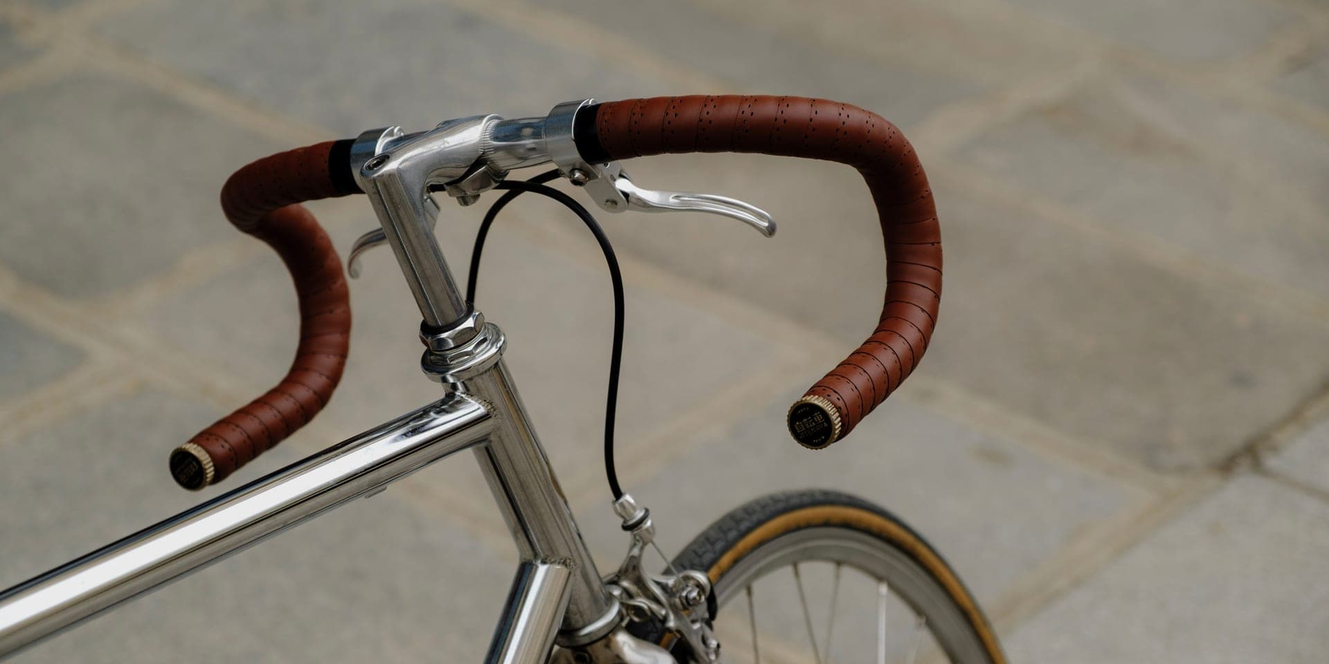 The drop handlebars of a road bike with fresh handlebar tape.