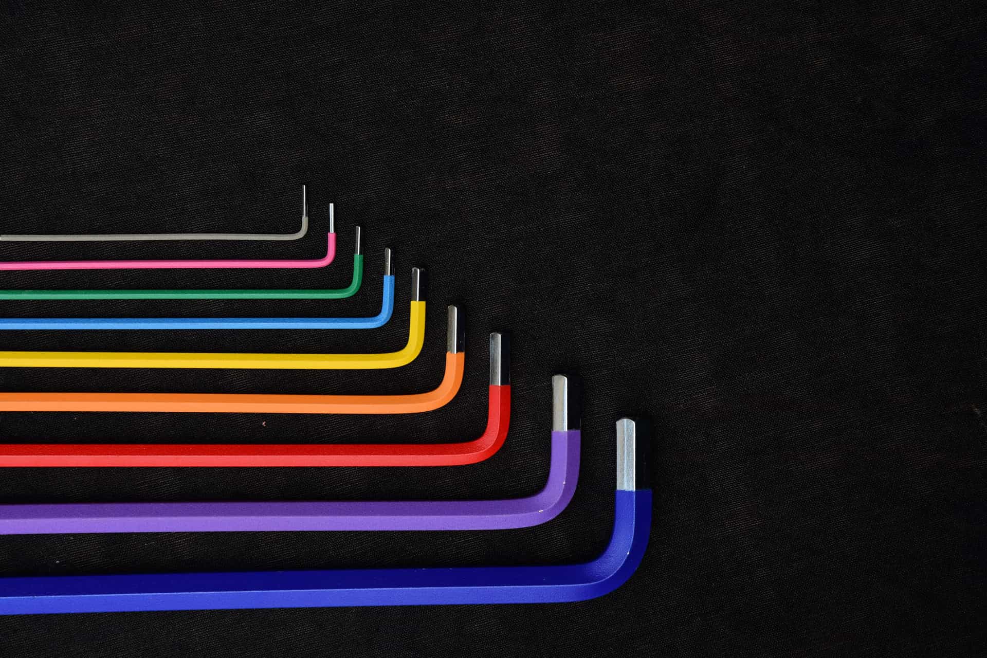 A set of colored hex keys laid out on a dark surface.