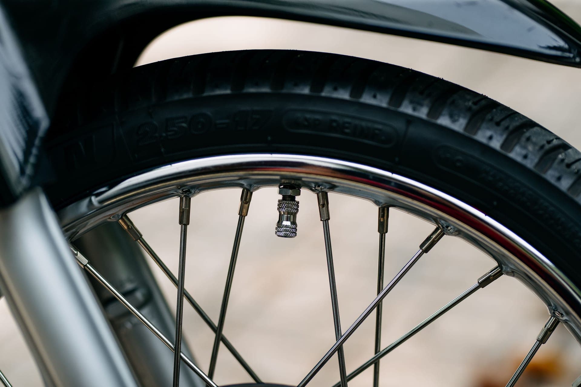 A bicycle wheel, tire and valve photographed close up.