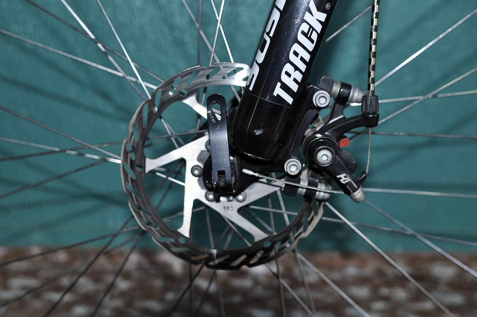 A bicycle disc brake caliper and rotor photographed close up.