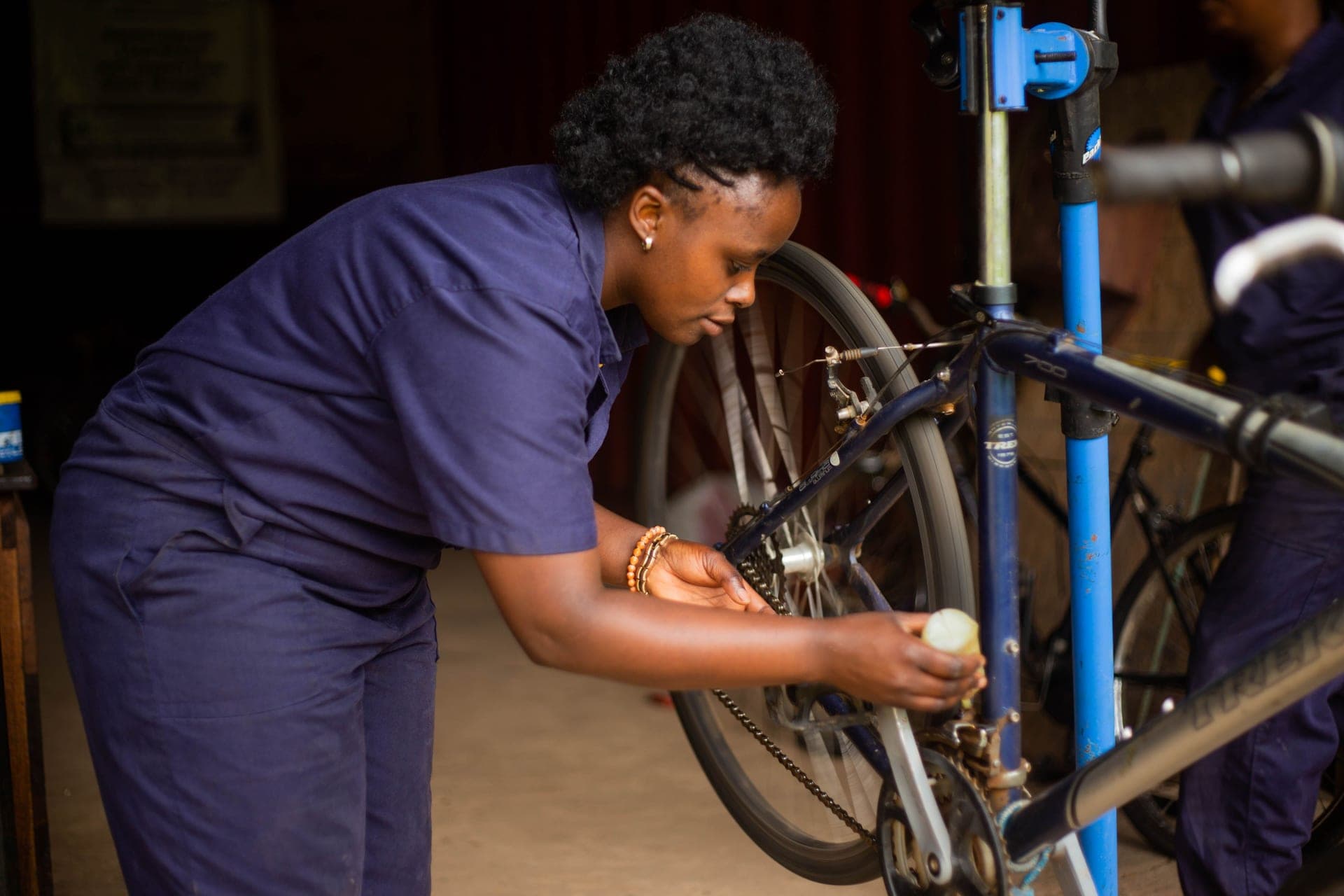 A chain wear indicator tool seated on a bicycle chain over the cassette.